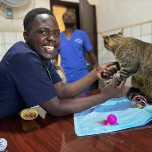 vet in Kampala vaccinating a cat at Superior Animal Clinic